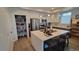 Bright kitchen with center island, modern lighting, and stainless steel appliances at 1295 Utica St, Denver, CO 80204