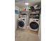 This laundry room has a side-by-side washer and dryer with shelving and a storage rack at 1295 Utica St, Denver, CO 80204