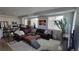 Open living room leading to kitchen with a large leather sofa, ottoman and soft rug at 1295 Utica St, Denver, CO 80204