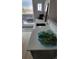 Modern wet bar area featuring a sink, sleek countertops, and views of the outdoor balcony at 1295 Utica St, Denver, CO 80204