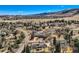 Expansive aerial view of a neighborhood nestled within a mountainous landscape, showcasing luxurious homes and beautiful surroundings at 19 Red Fox Ln, Littleton, CO 80127