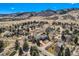 Expansive aerial view of a luxury home nestled in a serene community with mountain views at 19 Red Fox Ln, Littleton, CO 80127