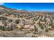 A beautiful aerial view of a home with a deck, nestled in a neighborhood near mountains, showcasing the property's scenic location at 19 Red Fox Ln, Littleton, CO 80127