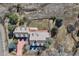 Aerial view of the home featuring a deck, mature trees, and a fenced yard at 19 Red Fox Ln, Littleton, CO 80127