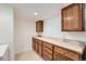 Basement laundry room with tile floor, countertop, ample cabinet storage, and washer and dryer hookups at 19 Red Fox Ln, Littleton, CO 80127