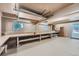 Basement workshop with workbench, pegboards, shelving, and windows for natural light at 19 Red Fox Ln, Littleton, CO 80127