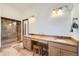 Bright bathroom features a double vanity, a glass shower and tile flooring at 19 Red Fox Ln, Littleton, CO 80127