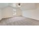 Bright bedroom features an attic ceiling, carpeted floors and a window at 19 Red Fox Ln, Littleton, CO 80127