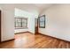 Bedroom with hardwood floors, built-in bench, and window with wooded view at 19 Red Fox Ln, Littleton, CO 80127