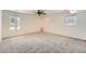 Spacious bedroom with neutral carpet, bright windows and a ceiling fan at 19 Red Fox Ln, Littleton, CO 80127