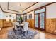 Formal dining room featuring wood paneling, elegant lighting, hardwood floors, and large windows at 19 Red Fox Ln, Littleton, CO 80127