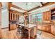 A well-appointed kitchen featuring exposed beams, a center island and stainless steel appliances at 19 Red Fox Ln, Littleton, CO 80127