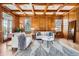 Cozy living room with hardwood floors, wood paneling, coffered ceiling, and plenty of natural light at 19 Red Fox Ln, Littleton, CO 80127