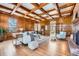 Living room features hardwood floors, wood paneling, coffered ceiling, fireplace, and natural light at 19 Red Fox Ln, Littleton, CO 80127