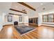 Vaulted living room with wood beams, fireplace, and custom built-ins at 19 Red Fox Ln, Littleton, CO 80127