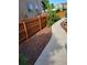 Backyard with stained wooden fence, concrete pathway, and neatly kept landscaping at 13349 Krameria St, Thornton, CO 80602