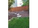 Backyard with stone pathway, mulch beds, and a wooden fence at 13349 Krameria St, Thornton, CO 80602