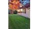 Landscaped backyard with a patio, colorful trees, and a wooden fence at 13349 Krameria St, Thornton, CO 80602