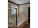 Bathroom with a large soaking tub and window at 13349 Krameria St, Thornton, CO 80602