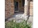 Covered front porch with stone facade and landscaping at 13349 Krameria St, Thornton, CO 80602