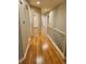 Long hallway with hardwood floors and access to bedrooms at 13349 Krameria St, Thornton, CO 80602