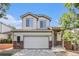 Charming two-story home featuring a two-car garage, brick accents, and a welcoming front porch at 20558 E Grand Ln, Aurora, CO 80015
