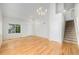Open-concept living area with vaulted ceilings, hardwood floors, and a staircase leading to the upper level at 20558 E Grand Ln, Aurora, CO 80015
