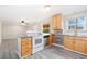 Open-concept kitchen featuring light wood cabinets, white appliances, wood flooring, and lots of natural light at 3270 W 92Nd Pl, Westminster, CO 80031