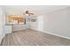 Open-concept living room featuring hardwood floors, updated walls, and a half-wall separating it from the kitchen at 3270 W 92Nd Pl, Westminster, CO 80031