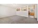 Bright living room featuring gray walls, neutral carpet, and a large cut-out wall looking into the kitchen at 3270 W 92Nd Pl, Westminster, CO 80031