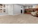 Basement area featuring a fireplace, carpeted floor, and an open doorway, creating a welcoming space at 8063 S Otis Ct, Littleton, CO 80128