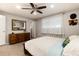 Bright bedroom featuring a plush bed, dresser, and a ceiling fan at 8063 S Otis Ct, Littleton, CO 80128
