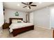 Well-lit bedroom featuring a plush bed, ceiling fan, and a neutral color scheme at 8063 S Otis Ct, Littleton, CO 80128