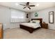 Bedroom features cozy carpet, a large window, and a warm wood bed frame creating a comfortable, relaxing space at 8063 S Otis Ct, Littleton, CO 80128