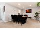Dining room with carpet, overhead lighting, large table with seating for six, and modern decor at 8063 S Otis Ct, Littleton, CO 80128