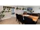 Bright dining area features a modern table with stylish chairs and plants around at 8063 S Otis Ct, Littleton, CO 80128