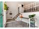 Welcoming entryway with tiled floor, staircase with decorative railing, and stylish décor at 8063 S Otis Ct, Littleton, CO 80128
