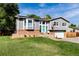 Charming two-story home with brick accents, a manicured lawn, and beautiful curb appeal on a sunny day at 8063 S Otis Ct, Littleton, CO 80128