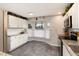 Bright kitchen featuring white cabinets, stainless steel appliances, and a sunlit window seating area at 8063 S Otis Ct, Littleton, CO 80128