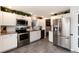 Well-equipped kitchen with stainless steel appliances, white cabinets, and modern finishes for easy meal preparation at 8063 S Otis Ct, Littleton, CO 80128