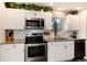 Bright kitchen with white cabinets, stainless steel appliances, granite countertops, and ample storage space at 8063 S Otis Ct, Littleton, CO 80128