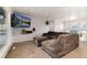 Living room with a large gray sectional couch, carpet flooring and access to an outdoor deck at 8063 S Otis Ct, Littleton, CO 80128