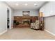 Cozy living room featuring a brick fireplace, carpeted floor, and comfortable seating, creating a warm atmosphere at 8063 S Otis Ct, Littleton, CO 80128