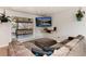 Cozy living room with comfortable seating, a large television, and plenty of natural light from the sliding glass door at 8063 S Otis Ct, Littleton, CO 80128