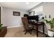 Functional office space featuring carpet, natural light, and work desk area, creating a productive environment at 8063 S Otis Ct, Littleton, CO 80128