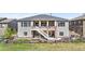 Exterior shot of home featuring a backyard patio and stairs to an upper deck at 8691 S Sicily Ct, Aurora, CO 80016