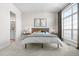 Bright bedroom featuring plush carpeting, a large window, and modern decor at 8691 S Sicily Ct, Aurora, CO 80016