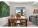 Dining area with modern table, statement wall art and natural light, perfect for entertaining at 8691 S Sicily Ct, Aurora, CO 80016
