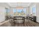 Bright dining room features a stylish light fixture, large windows with views, and an elegant dark wood table at 8691 S Sicily Ct, Aurora, CO 80016