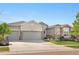 Beautiful home with stone accents, three-car garage, and well-maintained lawn in a desirable neighborhood at 8691 S Sicily Ct, Aurora, CO 80016
